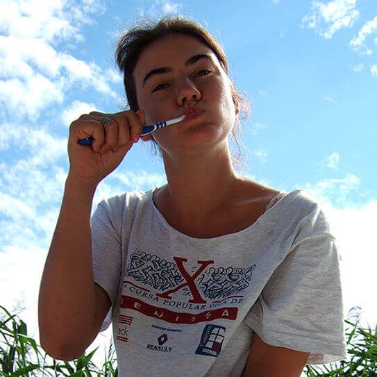 teen girl brushing her teeth