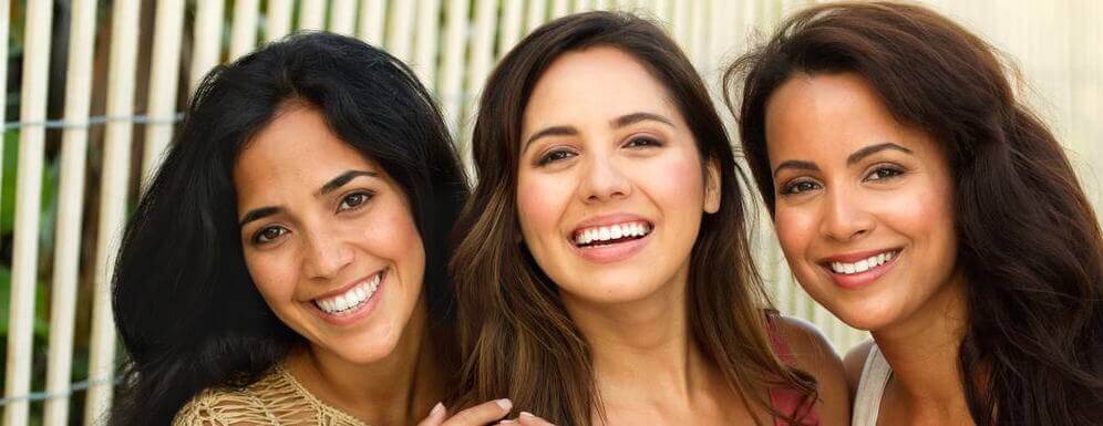 three women smiling with acceledent