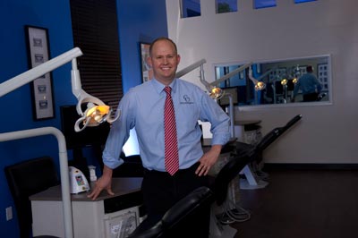 orthodontist standing by dentist's chairs